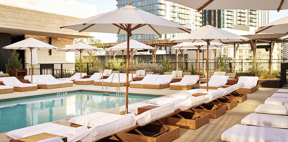 The pool deck at watr, 1 Hotel Austin's rooftop restaurant, overlooking Lady Bird Lake.