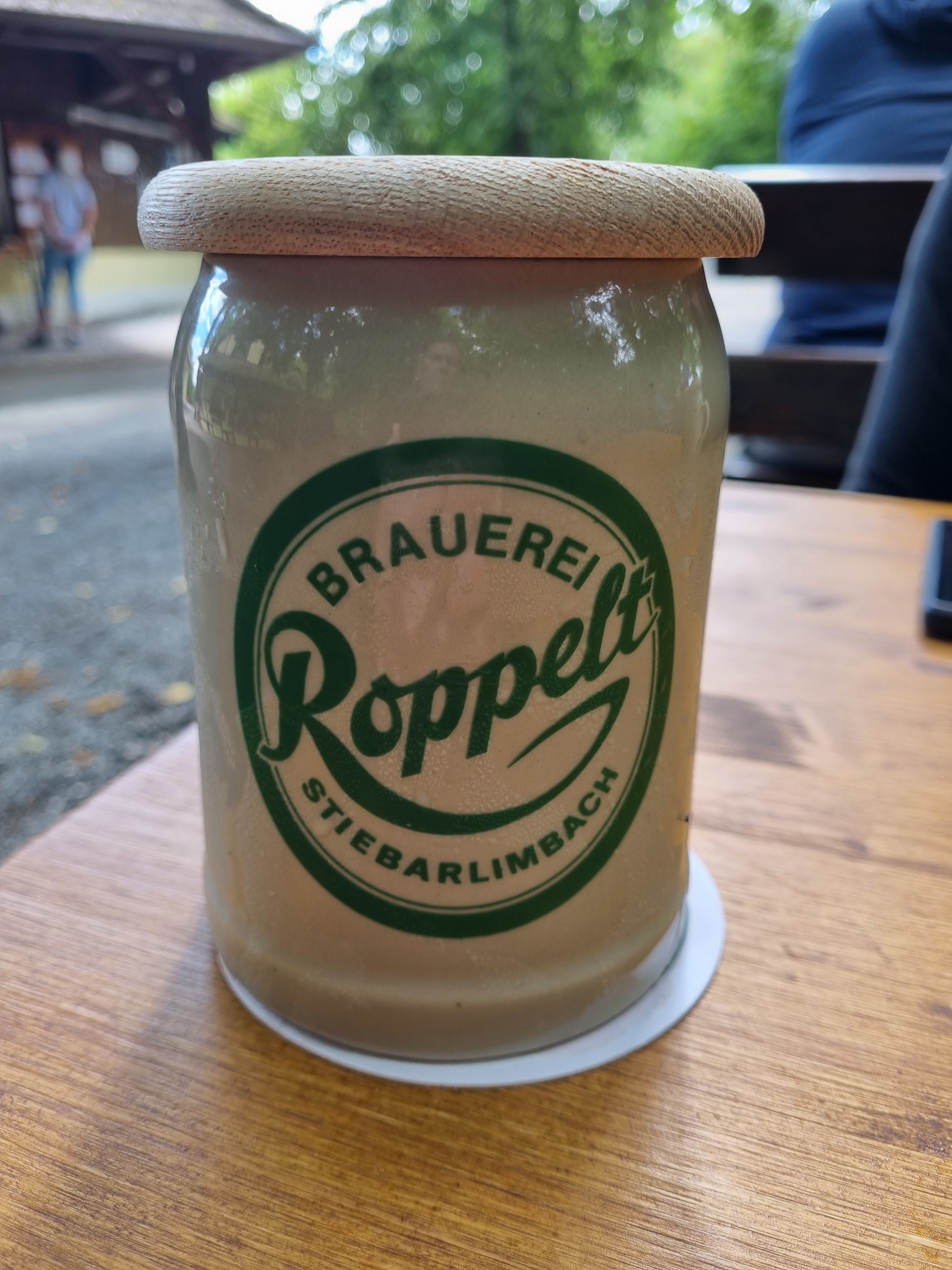 A stoneware Roppelt krug with wooden lid on a beer-keller table at Roppelt's Keller in Stiebarlimbach.