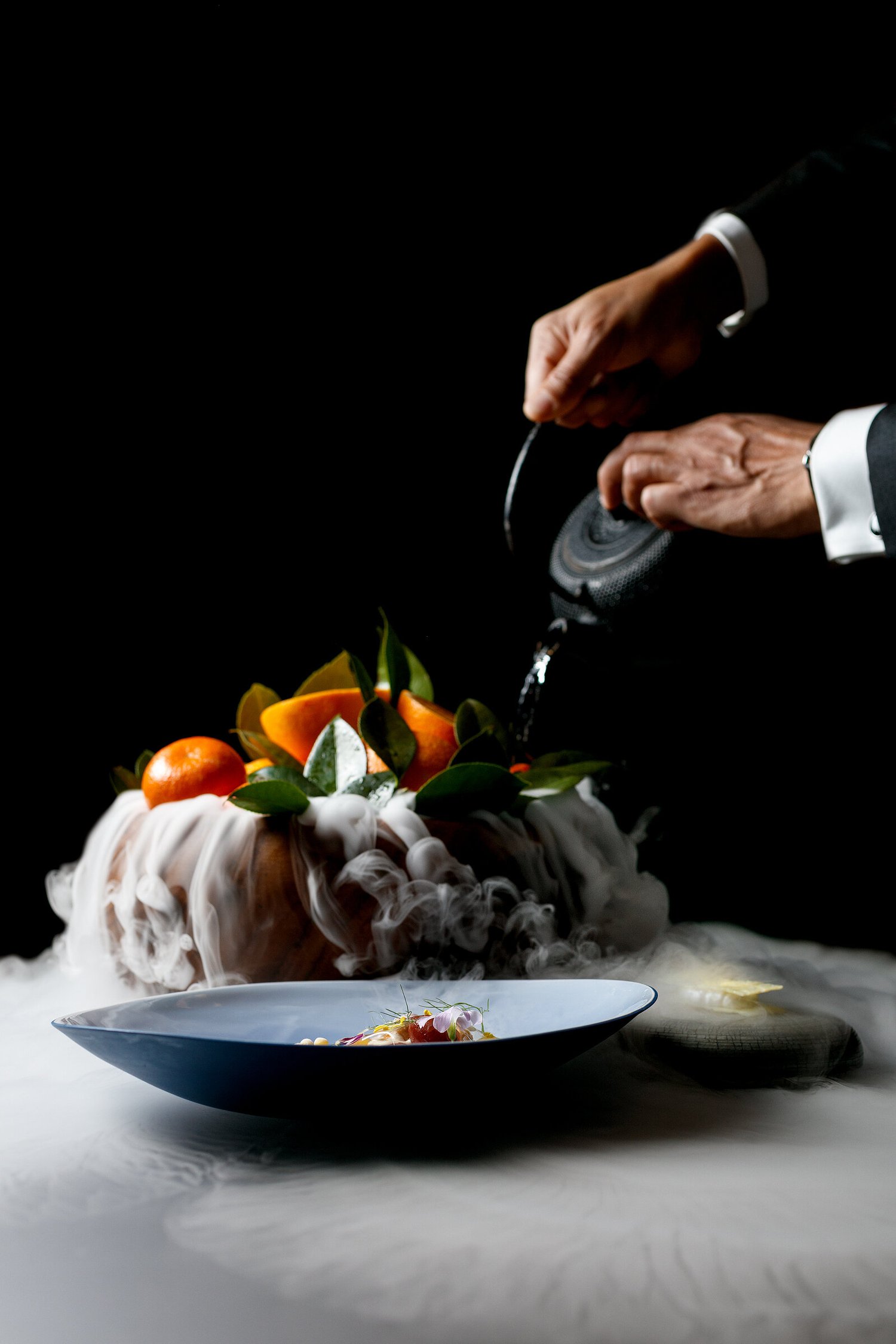 Server finishing a dish tableside at Alinea, Chicago