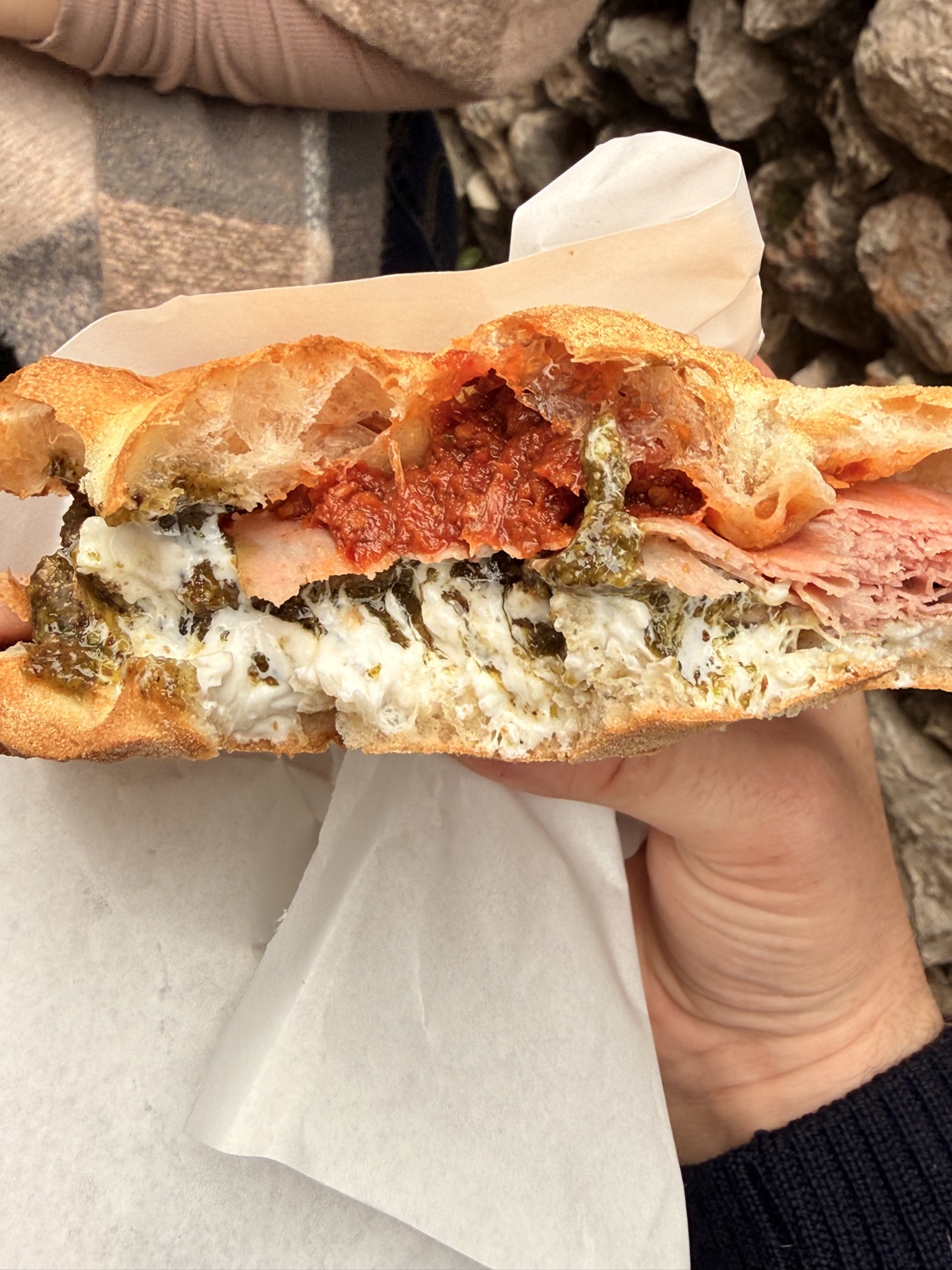 Cut-open mortadella and burrata focaccia sandwich