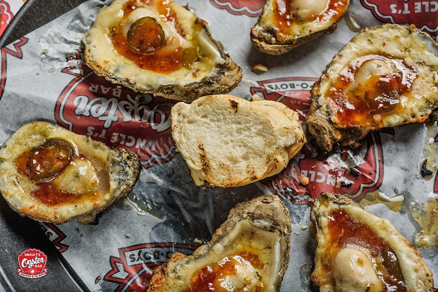 Charbroiled oysters with cheese and toppings at Uncle T's