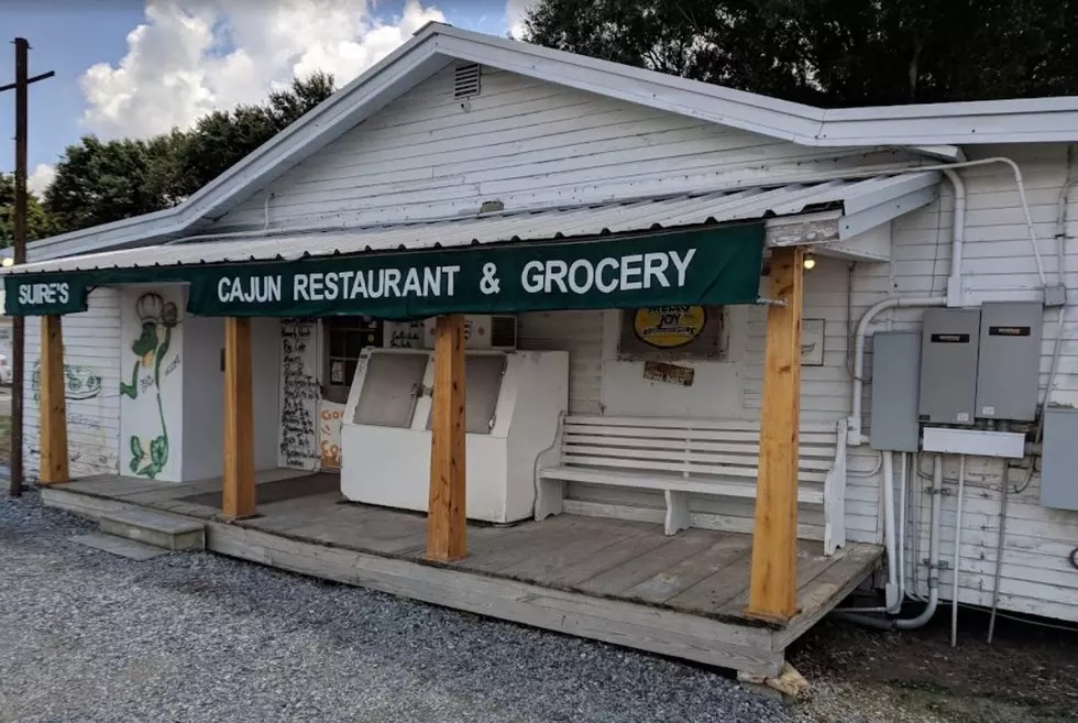 The Suire's storefront in Kaplan with the menu painted on it