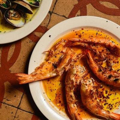 Louisiana white prawns a la plancha at Cervo's, glistening with paprika-spiced oil