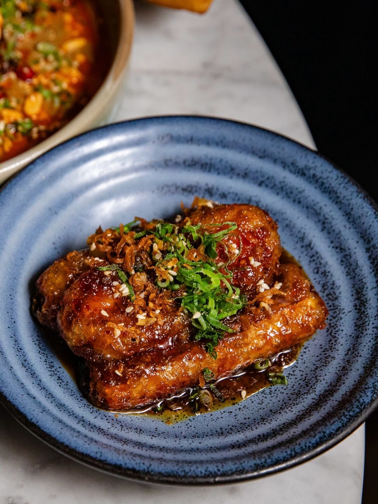 Chinese Tuxedo, signature crispy eggplant with sesame, scallions, and chili