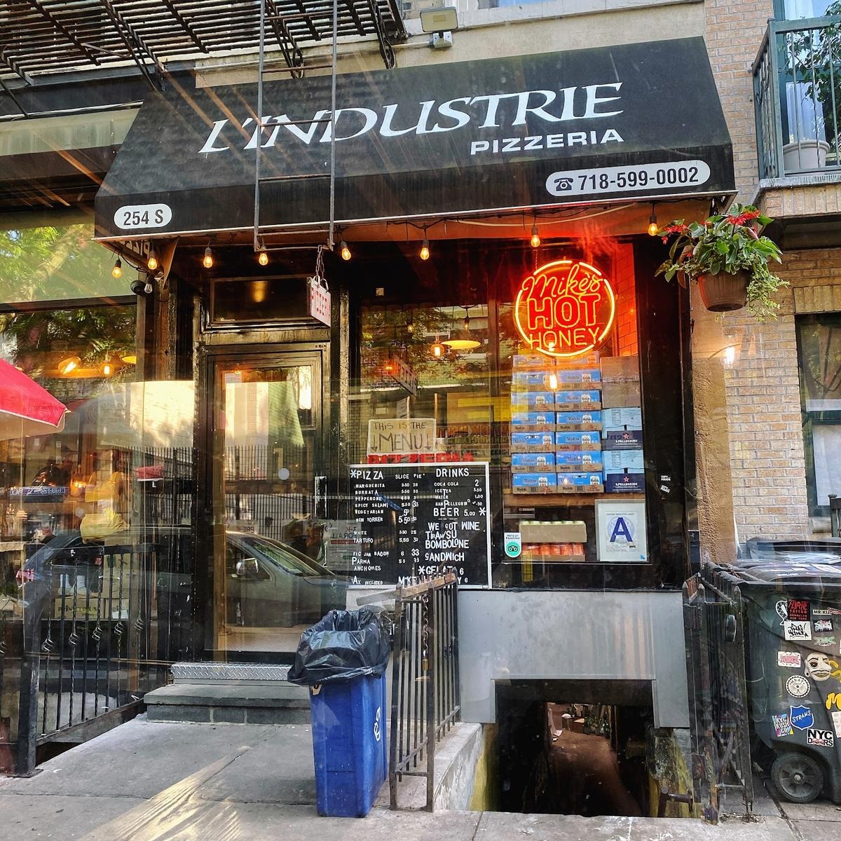 L'Industrie Pizzeria storefront at 254 S 2nd St, Williamsburg, with Mike's Hot Honey neon in the window