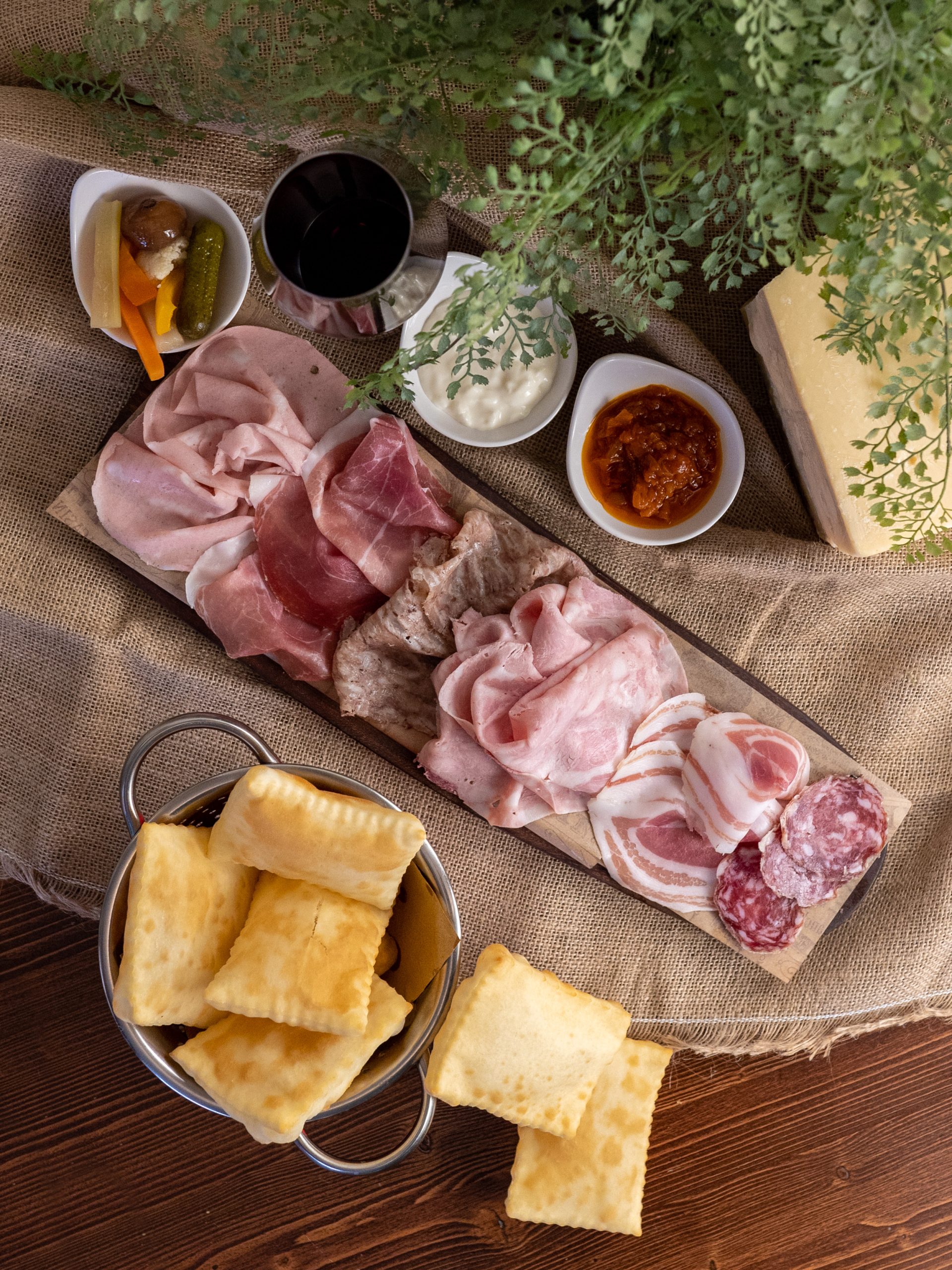 Crescentine at Trattoria Da Me in Bologna — puffy blistered flatbreads served hot alongside salumi