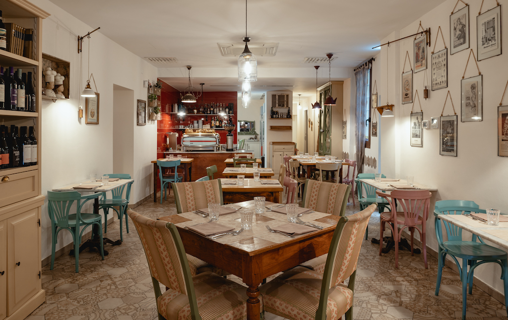 The dining room at Trattoria Da Me in Bologna — the family trattoria's main room, set for service