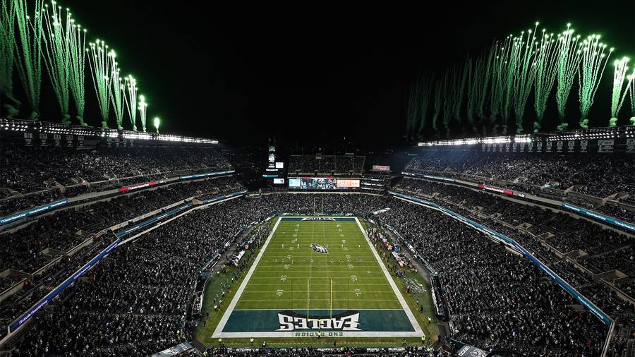 Lincoln Financial Field glowing at night.