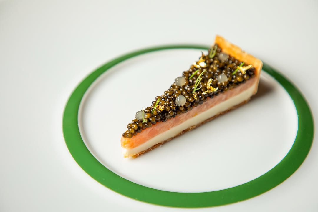 Emeril's smoked salmon cheesecake crowned with caviar, a signature dish for 36 years.