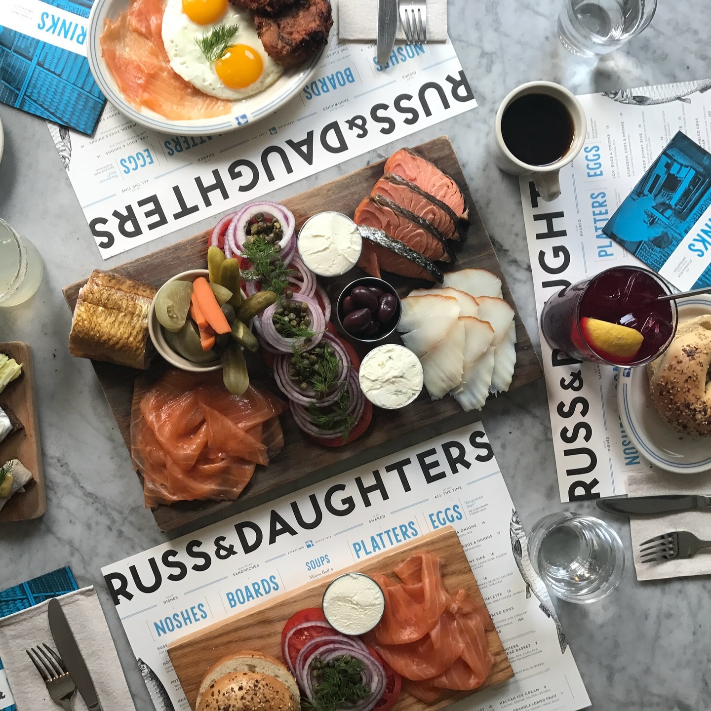 Smoked-fish platters at the Russ & Daughters Cafe — sliced smoked whitefish, lox, capers, onions, and bagels