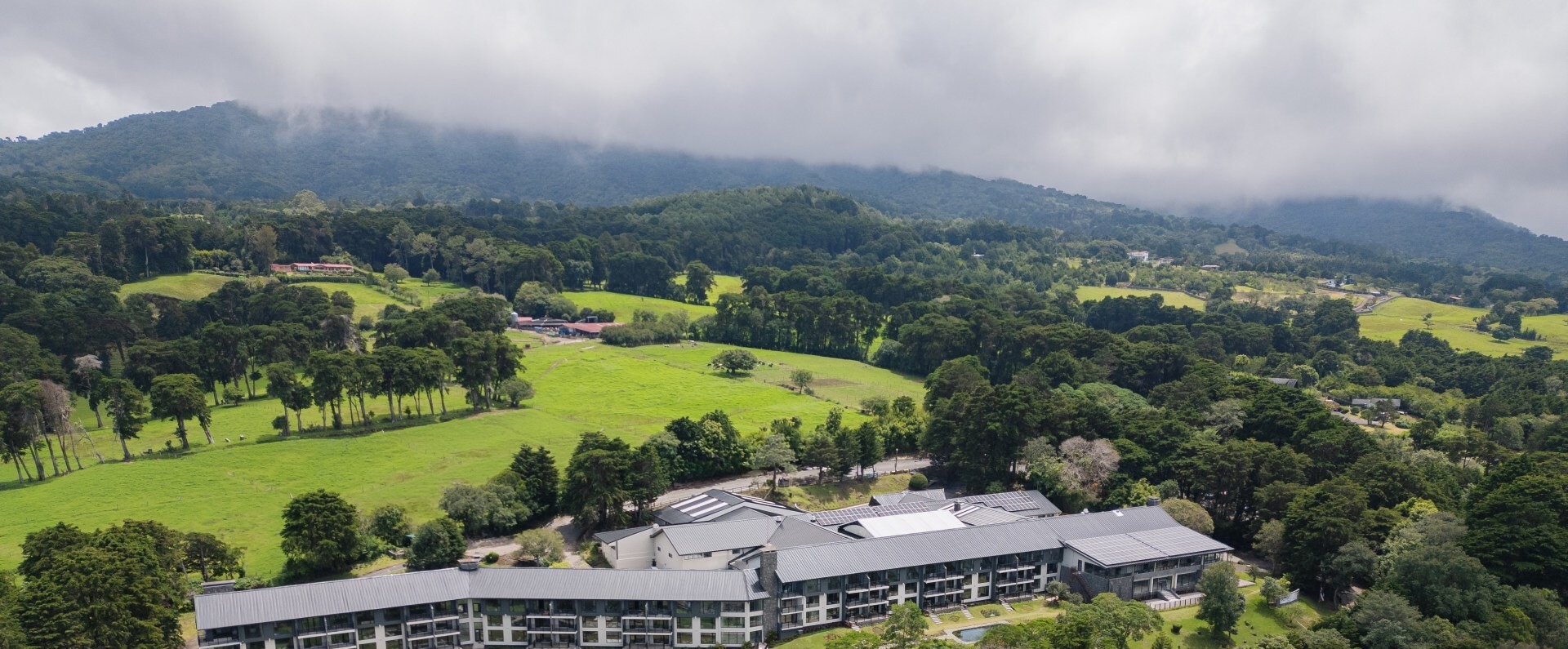 Aerial view of the Montara Hotel in the hills of Heredia, Costa Rica, surrounded by green mountain grounds.