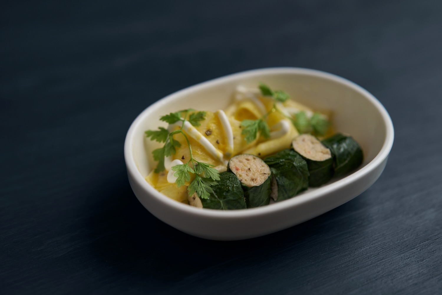 Manu Buffara's collard green roll filled with shrimp, served with passion fruit citrus sauce.