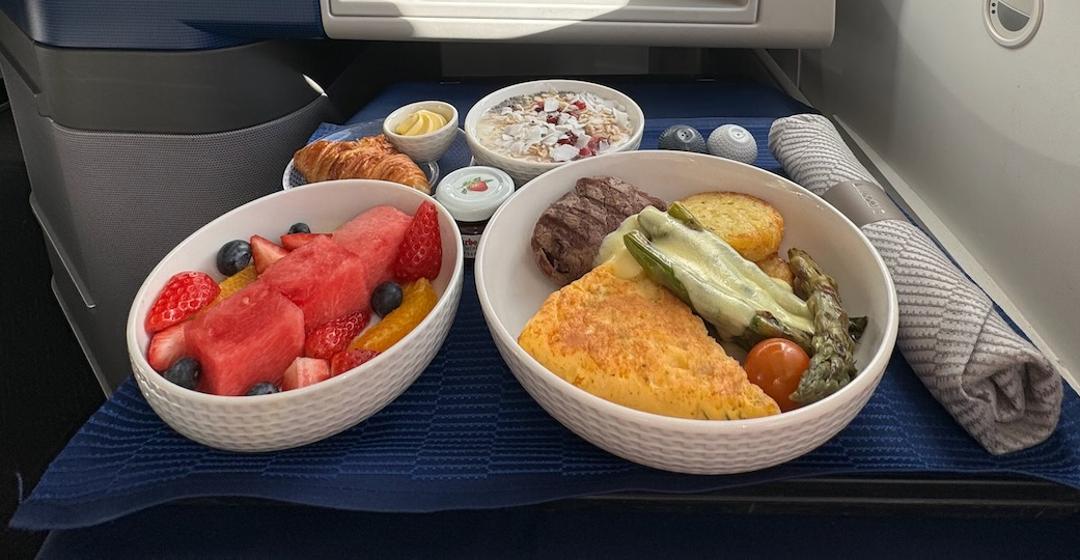 A United Polaris business-class tray with a chef-driven dish.
