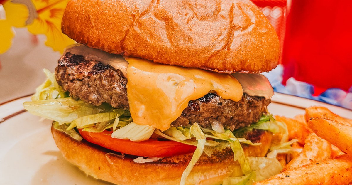 Cherry Cricket's Burger of the Month in Denver — smashed patty, molten cheese, shredded lettuce and tomato on a toasted bun with fries.