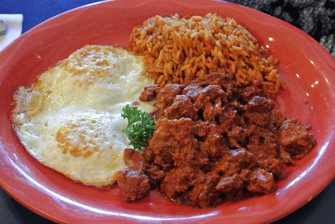 The Pantry's carne adovada breakfast plate in Santa Fe — tender pork marinated in red chile with two fried eggs and Spanish rice