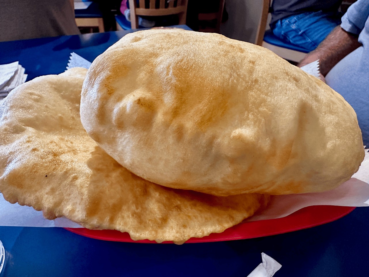 The Pantry's puffy golden sopaipillas in Santa Fe, served piping hot with real honey — thick with big air pockets, roughly the size of a zeppelin