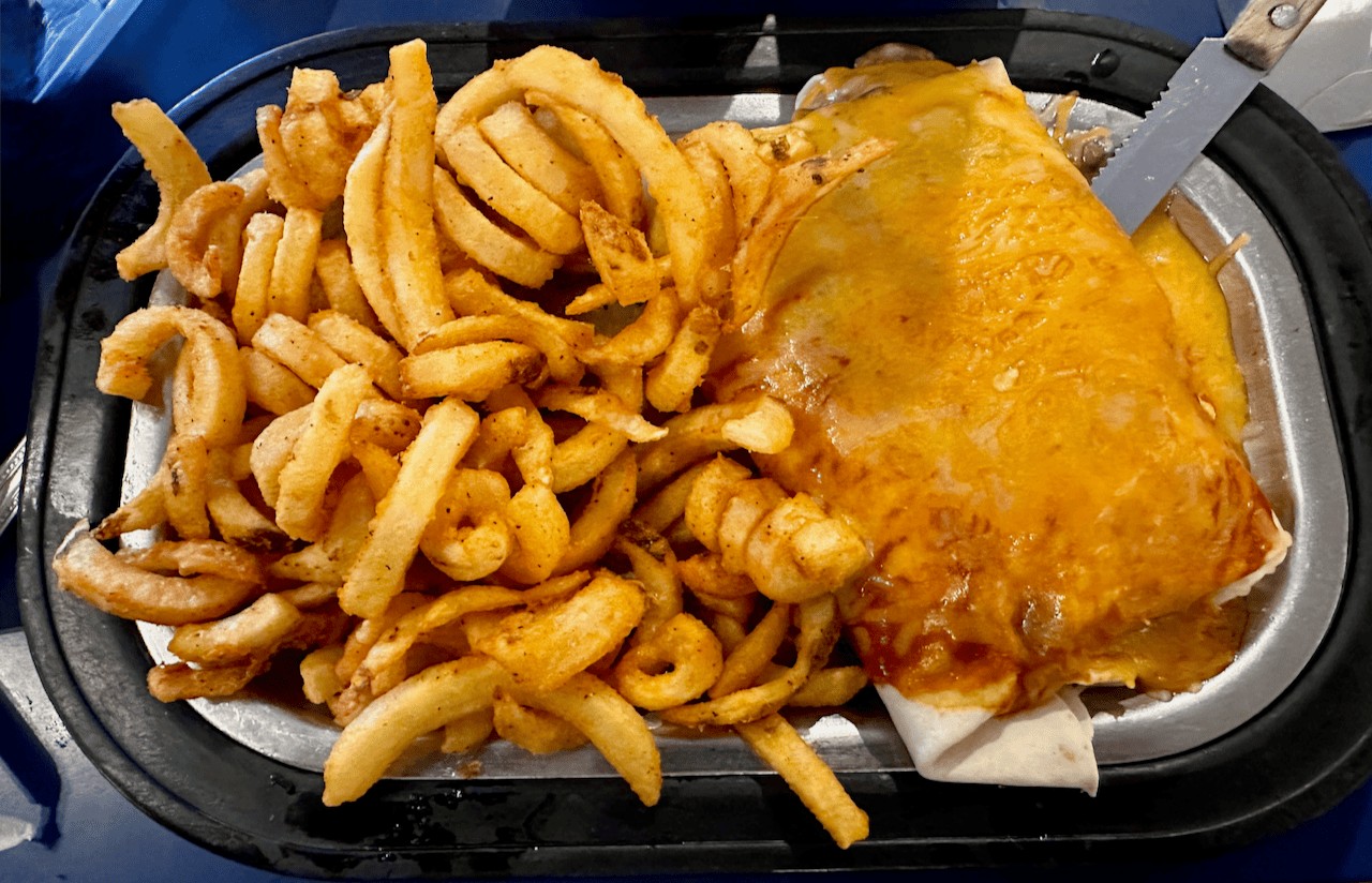 The Pantry's tortilla burger in Santa Fe — a char-grilled beef patty with beans wrapped in a tortilla and smothered in red chile, served with curly cue fries