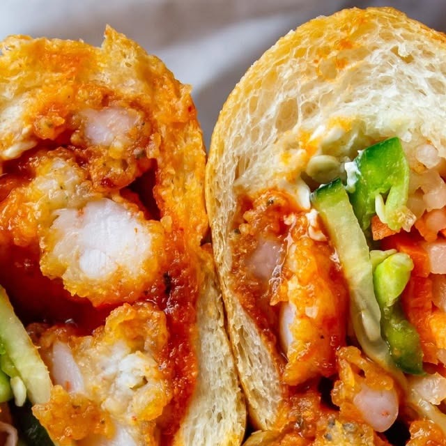 A fried shrimp banh mi with Thai-chili glaze, pickled vegetables, and jalapeño.