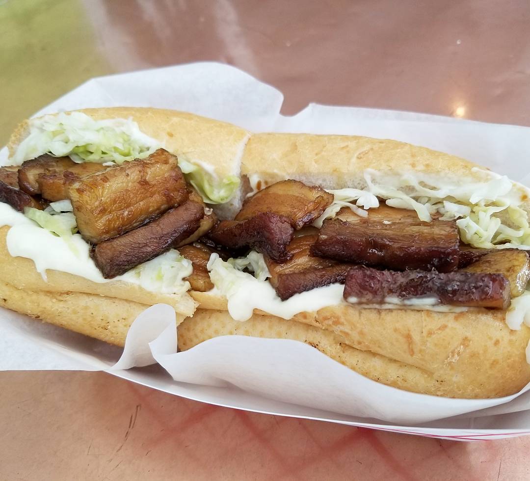 The Dark & Stormy po'boy at Killer Poboys: rum-glazed pork belly with lime slaw and garlic aioli.