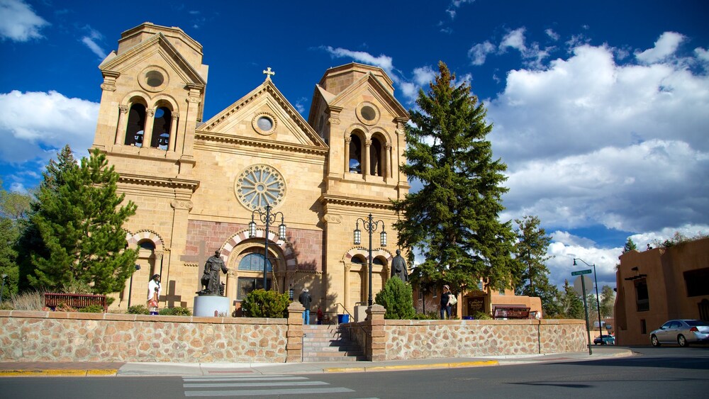 Downtown Santa Fe, New Mexico, with adobe buildings under a wide blue sky.