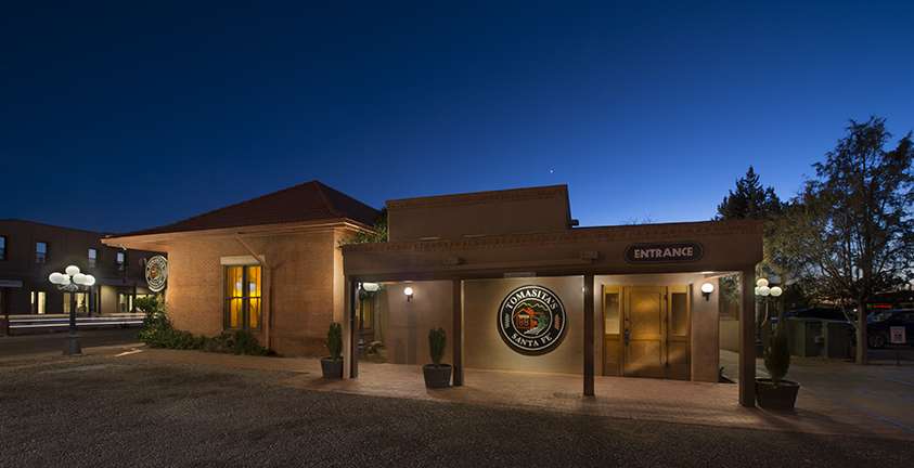 Tomasita's adobe exterior at dusk in the Railyard