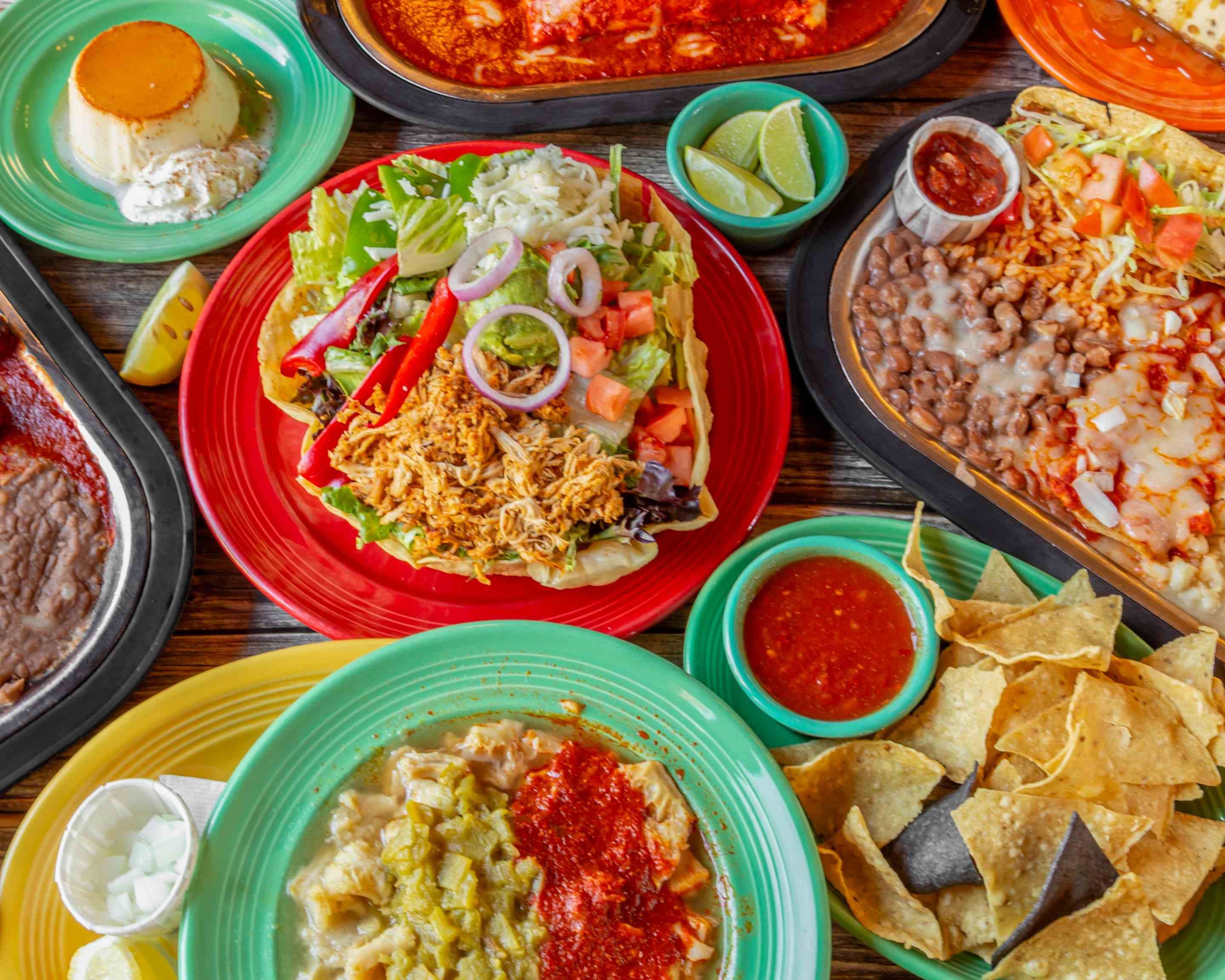 A spread of New Mexican dishes at Tomasita's in Santa Fe, including red chile enchiladas, tacos, beans and rice, and flan